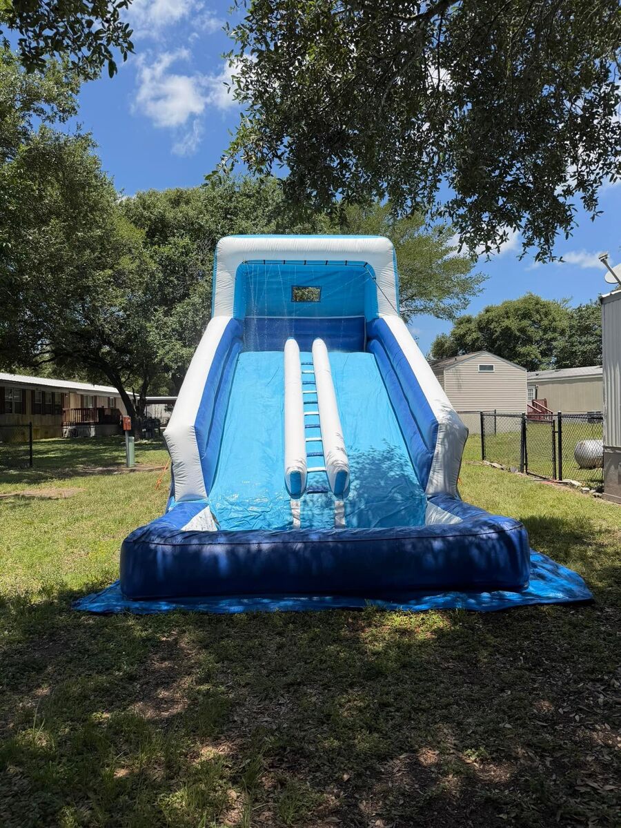Blue and white double-lane inflatable water slide with a splash pool